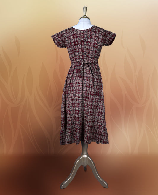 Classy maroon colour nightwear with intricate circular patterns in beige and black, Designed with a V neckline, short sleeves, and a flared hemline. Ideal for casual outings, workwear, or ethnic inspired looks.