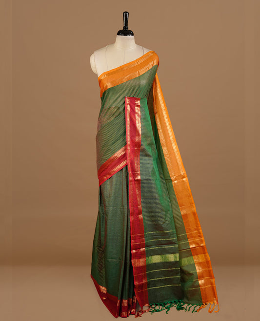 Green colour chettinad cotton saree featuring gold zari stripes on body, complemented by red colour with zari border, paired with matching blouse piece.