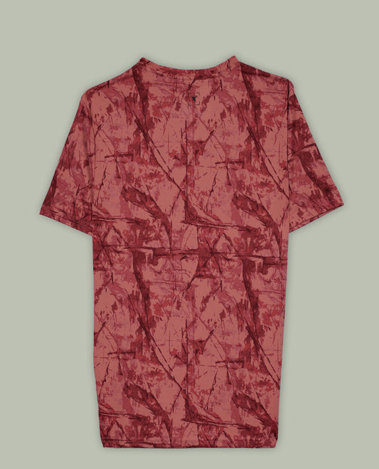 Light coral colour T shirt featuring a bold abstract tie dye pattern in darker red tones, designed with a classic round neck and short sleeves for a relaxed and stylish everyday look.
