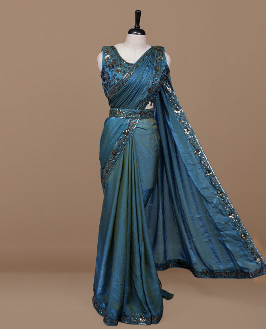 Gold & blue double shade designer saree features Elegant plain body, highlights Sequins & cut beats on border, paired with ready made blouse.