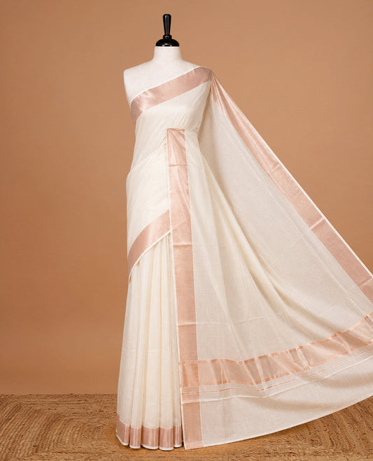 Cream colour Kerala saree featuring Rose Gold stripes on body, enrich by classy zari Border, pallu ,comes with matching blouse piece.