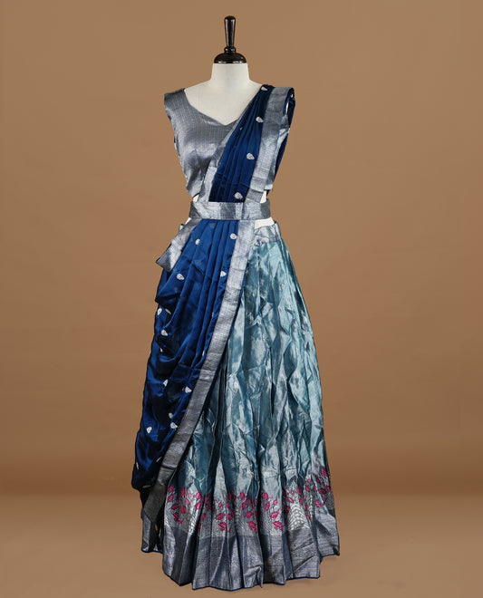 Bluish silver colour Half saree featuring Bluish silver skirt with contrast dark blue colour with silver zari traditional with floral pattern border, paired with matching dupatta, stitched blouse piece.