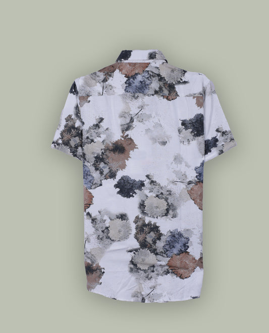 White colour short sleeve shirt features a rounded spread collar and a watercolor style floral print in brown, black, and blue & its ideal for both casual days and laid back evenings.