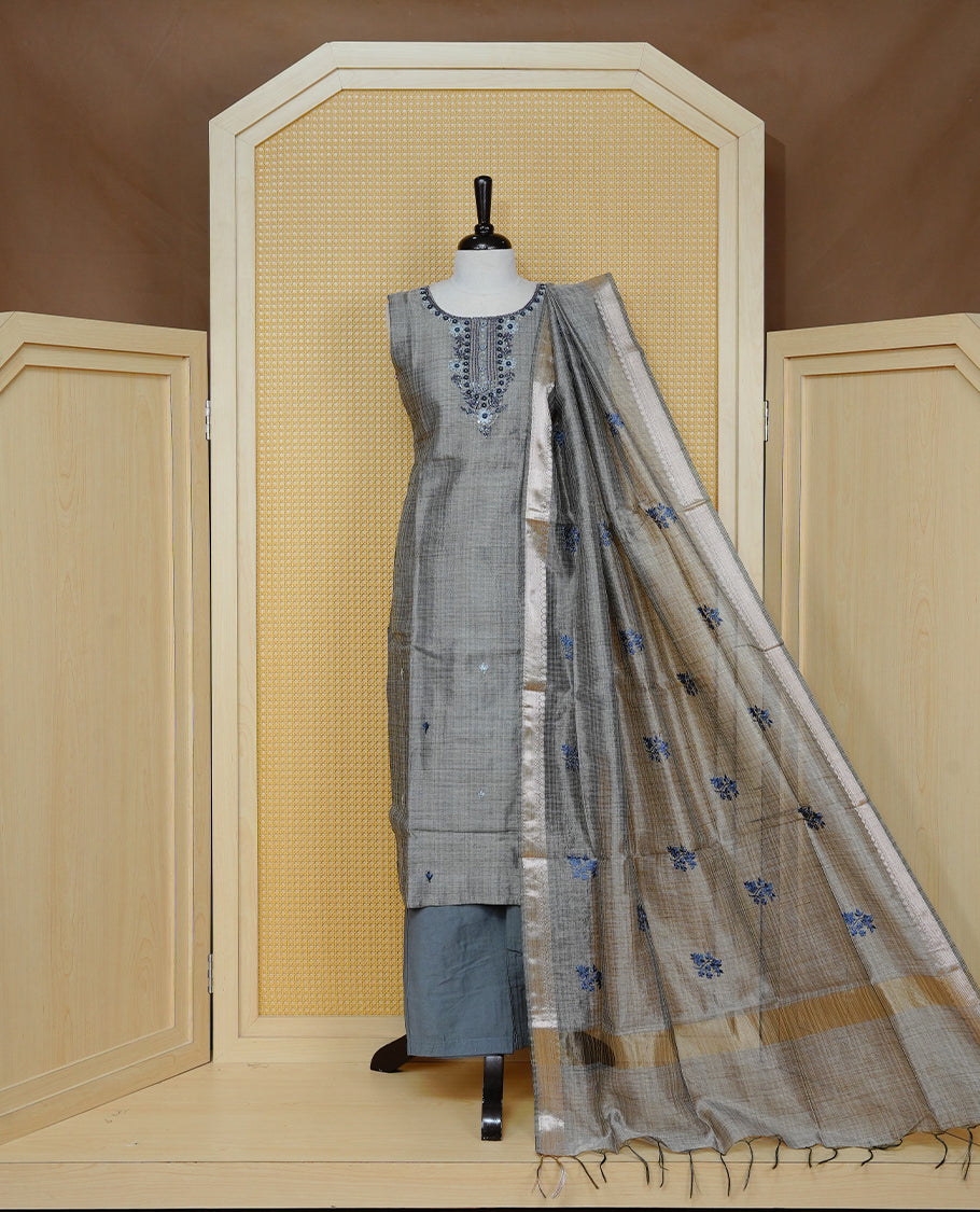 Blue colour Tissue Churidar Set featuring delicate floral embroidery and subtle bead detailing on the yoke, paired with matching solid pants and dupatta.
