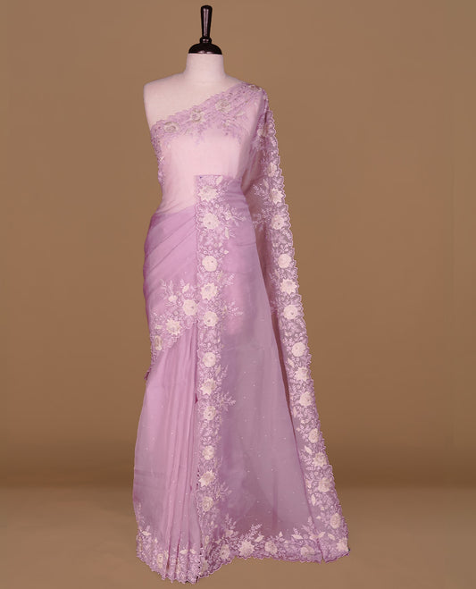 Pastel purple colour organza saree featuring thread with cut beats & sequins floral pattern on body, highlighting scalp border, paired with matching blouse piece.
