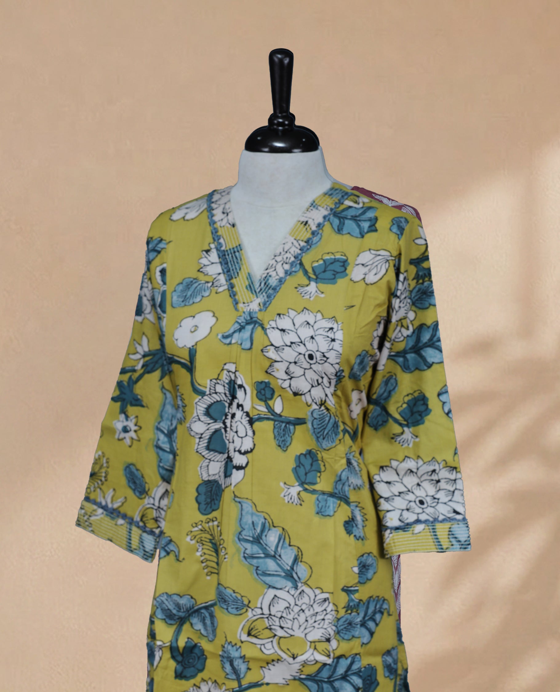 Dark Yellow kurti featuring a classic V-shaped neckline, intricate White & Teal Floral Prints on the body, and sleeves.