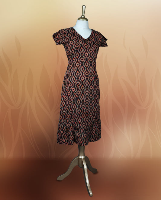 Brownish black colour nightwear with an elegant red and beige ethnic print, Features a flattering V neck, short sleeves, and a flared hem, Ideal for casual outings, festive gatherings, or comfortable daily wear.