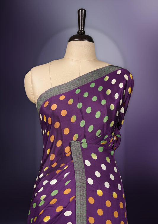 Purple colour saree with with large big polka dots on the body, self stripped pallu & Comes with a stylish matching blouse.