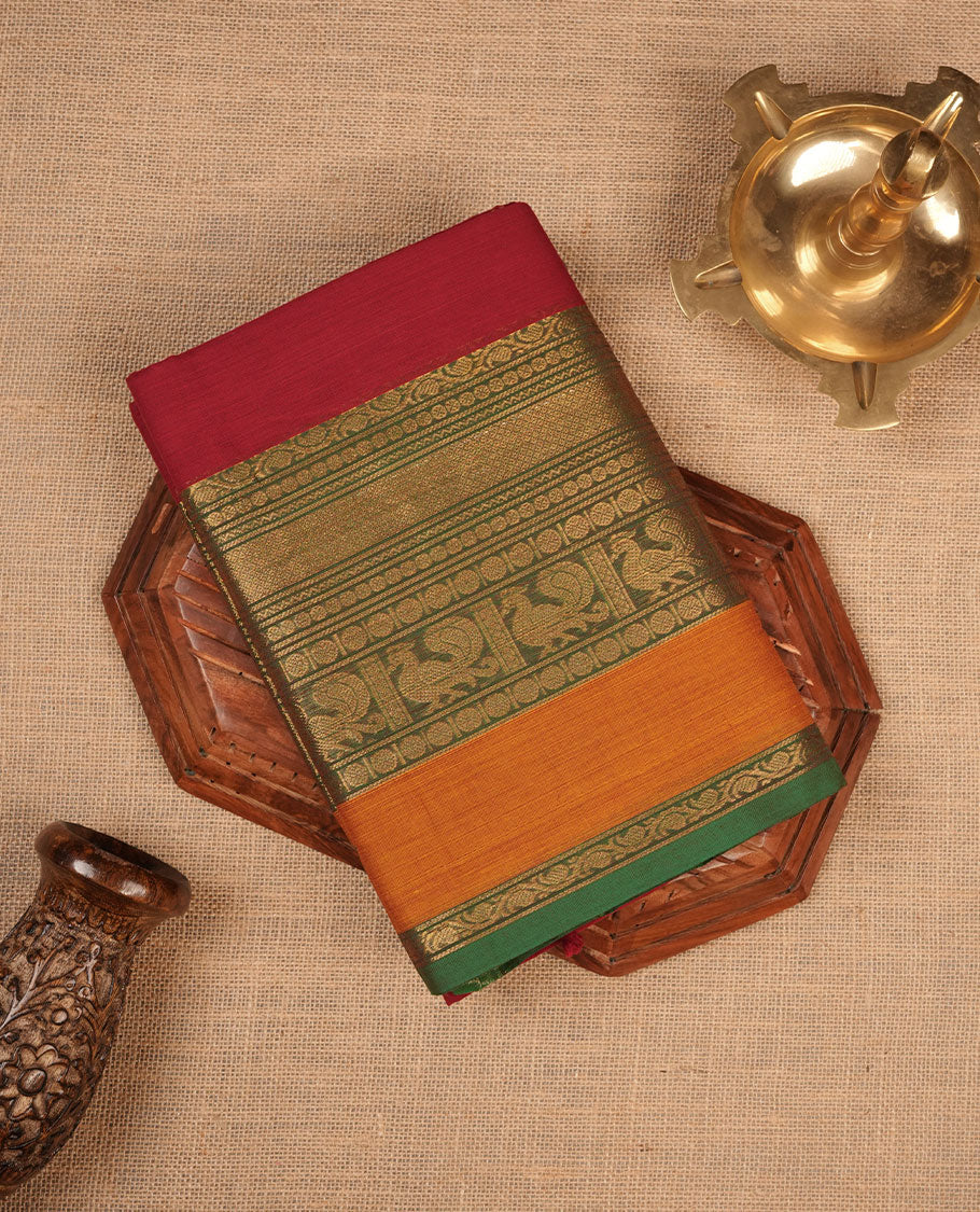 Red colour chettinad cotton saree featuring Elegant plain body highlighting contrast Green and mustrad colour colour with gold zari traditional border, pallu and paired with matching blouse piece.