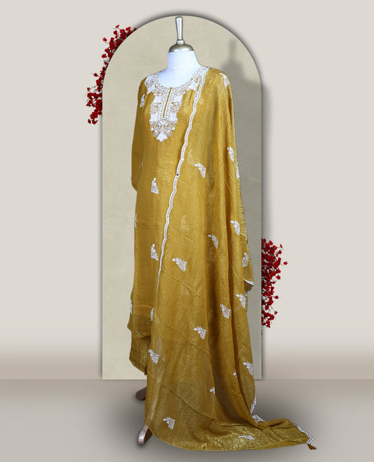 Mustard yellow churidar set featuring elegant white thread embroidery on the neckline, sleeves, and scattered motifs across the body, Paired with a matching embroidered dupatta, this ensemble radiates graceful charm and festive appeal.