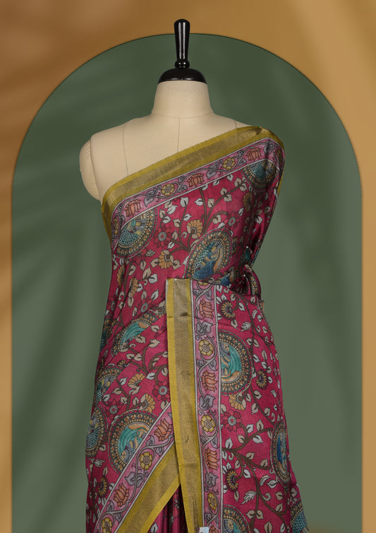 Reddish maroon colour saree adorned with intricate floral and paisley motifs, featuring a vibrant Madhubani style pallu and olive gold border & Paired with a matching blouse.