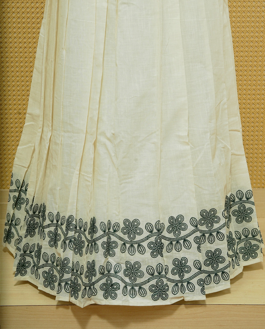 Cream colour cotton Stitched Skirt With Green colour Floral thread pattern on the border.