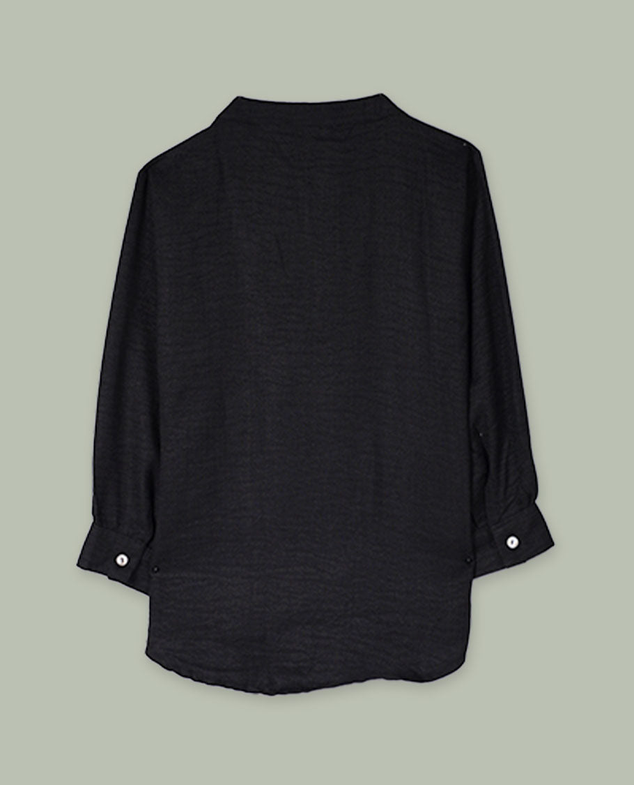 Black three-quarter sleeve tunic top with band collar, half button placket, and contrast white abstract cord embroidery along the hem.