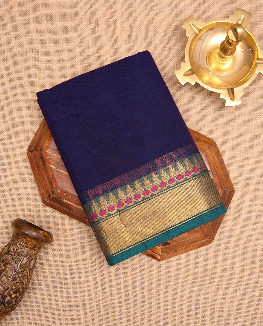 Navy Blue colour chettinad cotton saree featuring Elegant plain body, contrast green colour border with gold zari border, pallu and paired with matching blouse.