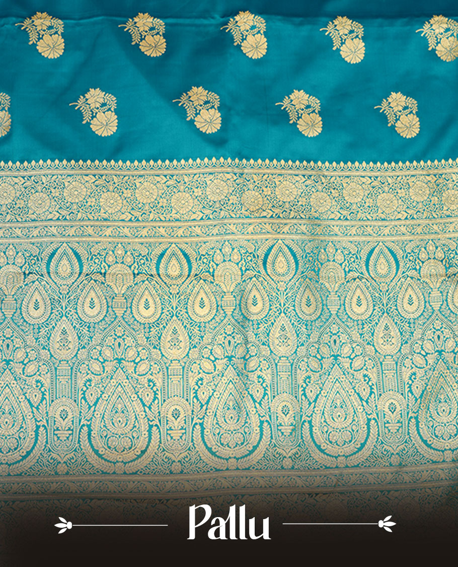 Teal blue colour Banaras Satin Crepe saree featuring gold zari floral motifs on the body, a richly woven traditional border with intricate gold zari detailing, and paired with a matching blouse.