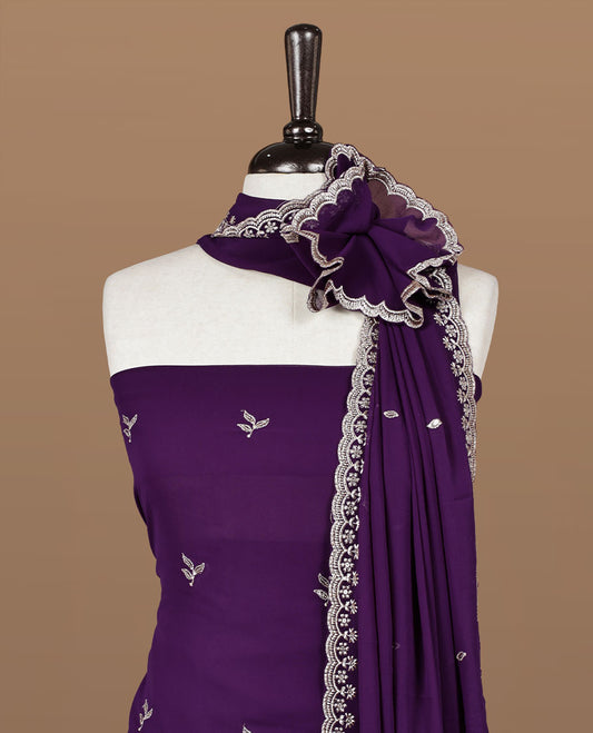 Purple colour churidhar material featuring gold thread floral pattern on body, paired with matching bottom & dupatta.