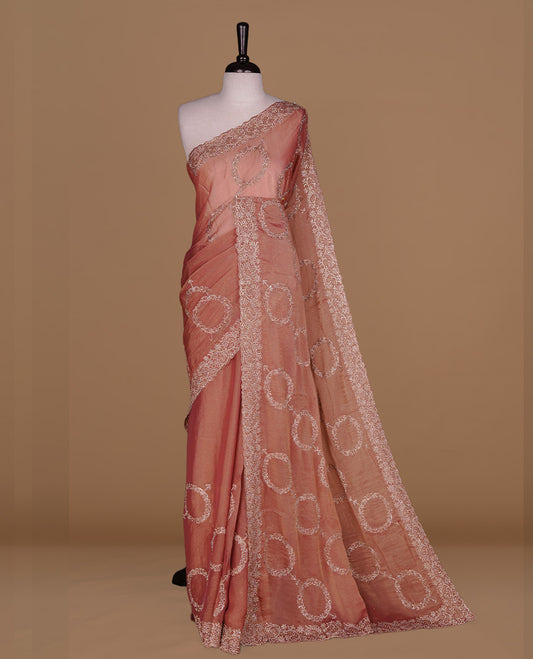 Pinkish orange colour organza saree featuring thread & gold stone pattern on body, highlighting scalp border, paired with Matching blouse piece.