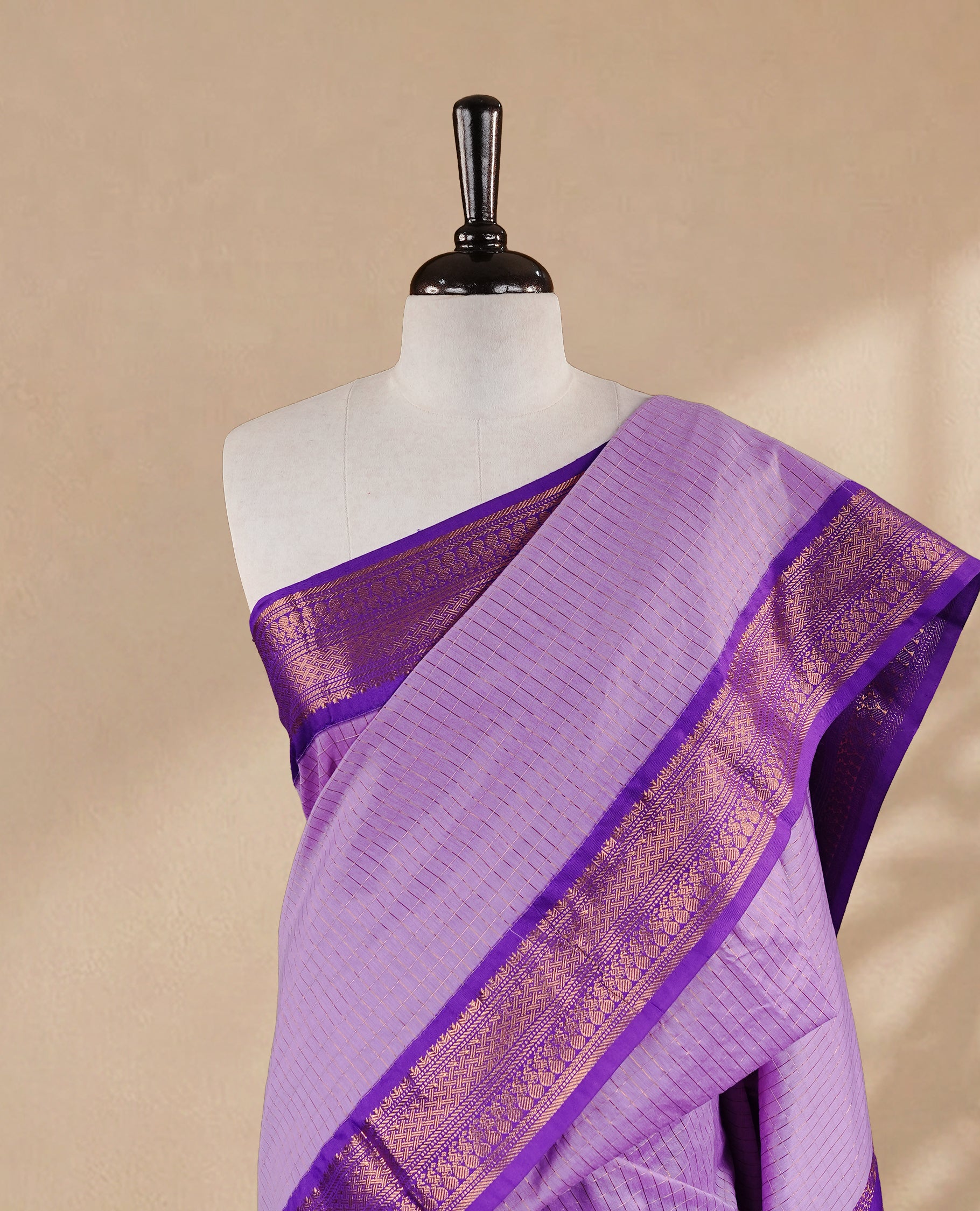 Lavender colour kalyani cotton saree featuring gold zari check pattern on body, complemented by Violet colour with Antique zari border, paired with matching blouse piece.