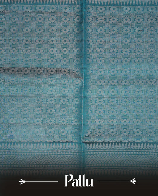 Teal colour soft silk saree featuring silver zari motifs on body, complemented by self colour with traditional border with tassel at pallu, paired with matching blouse piece.
