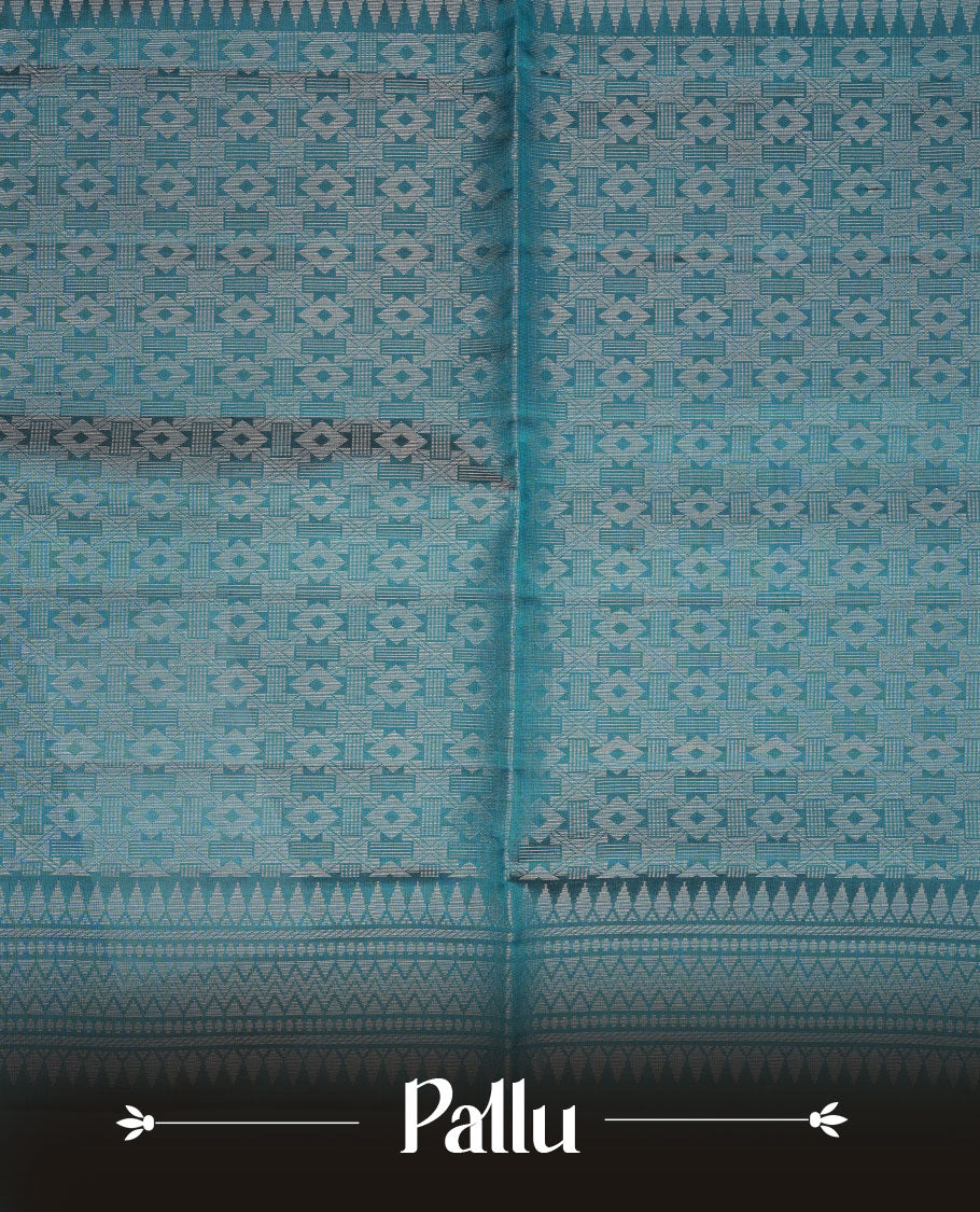 Teal colour soft silk saree featuring silver zari motifs on body, complemented by self colour with traditional border with tassel at pallu, paired with matching blouse piece.