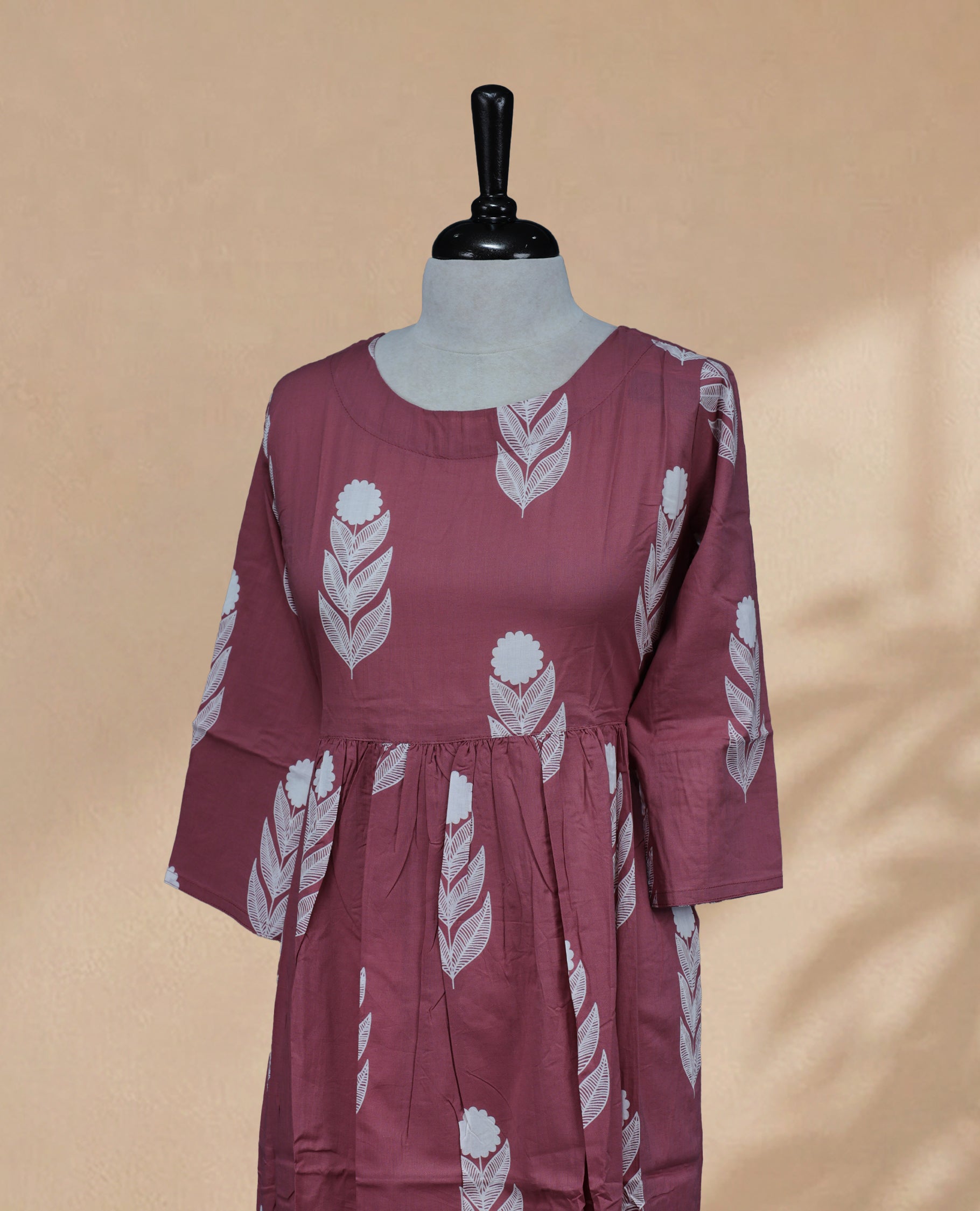 Dusty Rose kurti featuring a classic U-shaped neckline, White Floral Prints on the body, and sleeves.