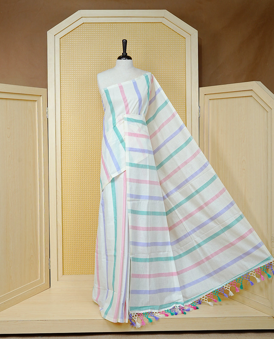 Cream colour Cotton kerala saree featuring Pink, green, purple colour stripes on body,  Finished with tassels on Pallu, paired with matching blouse piece.