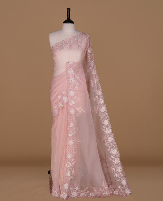 Pastel pink colour organza saree featuring thread with cut beats & sequins floral pattern on body, highlighting scalp border, paired with matching blouse piece.