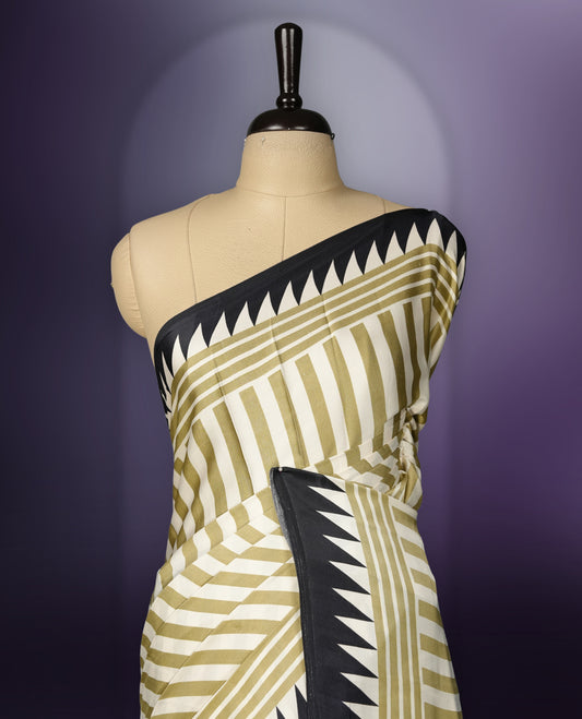 Beige colour saree with olive green stripes, highlighted by a striking black geometric border and a beautifully patterned pallu with intricate motifs, comes with a matching blouse.