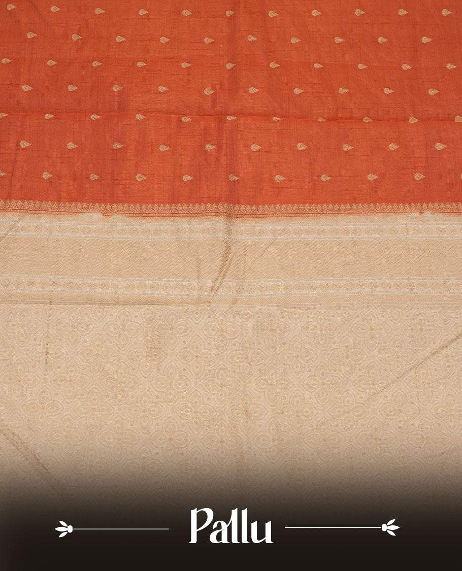 Orange colour tussar saree featuring litte gold zari motifs on body, contrast cream colour border and pallu with zari woven design, comes with matching blouse piece.