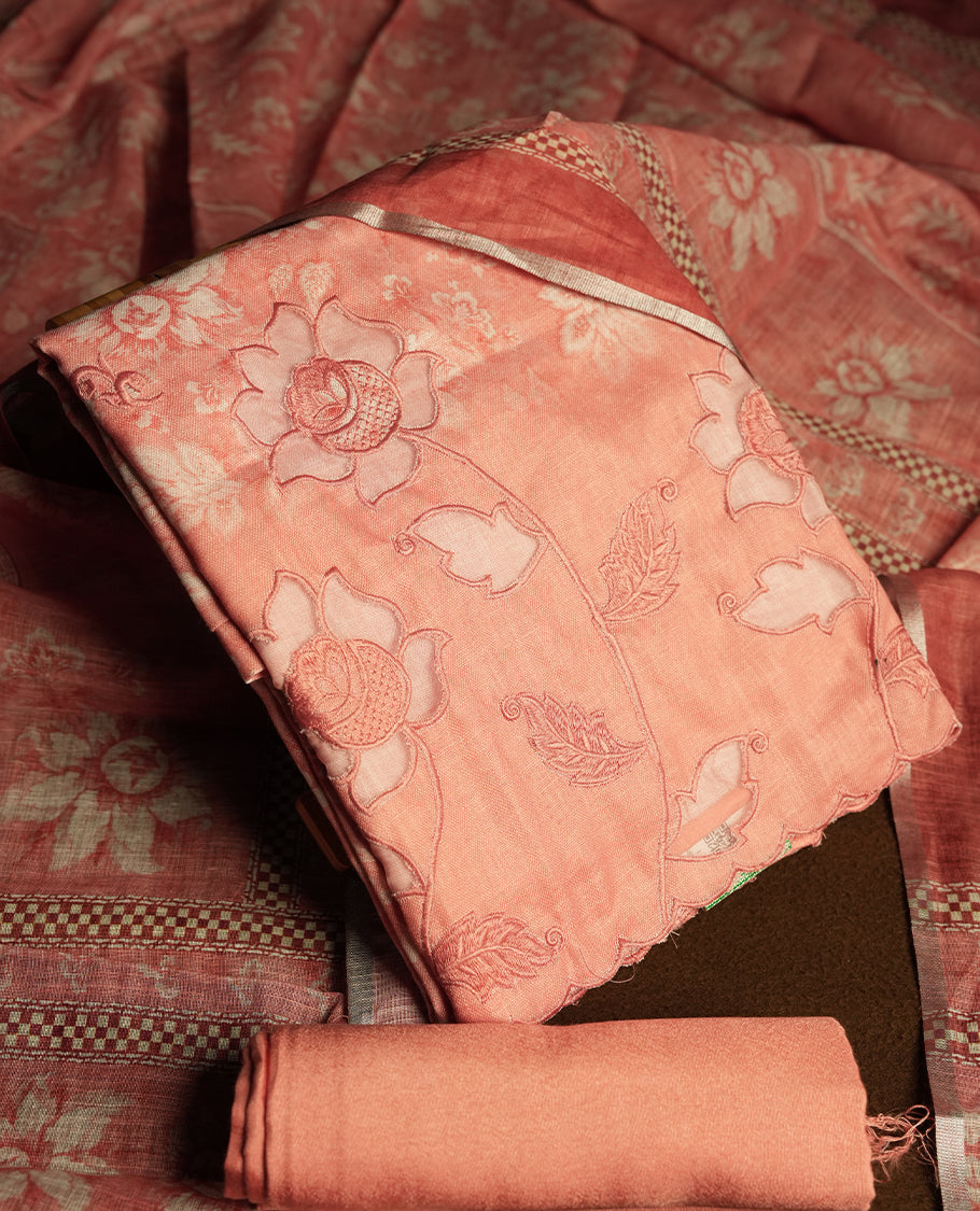 Peach colour churidhar material featuring cutwork and thread embroidery on the front panel, floral digital printed dupatta with elegant border, and matching plain bottom.