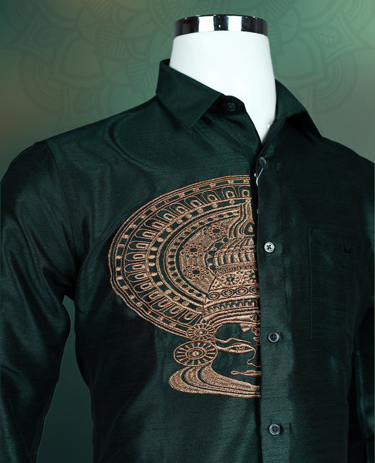 Olive green colour semi silk shirt featuring an exquisite golden Kathakali face fancy print on the chest, styled with a classic collar, full sleeves, and chest pocket, perfect for festive and traditional occasions.