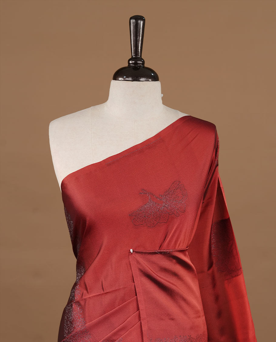 Red soft silk saree features a sleek borderless design with intricate antique zari motifs, flowing into a seamless self colored pallu and a matching blouse piece.