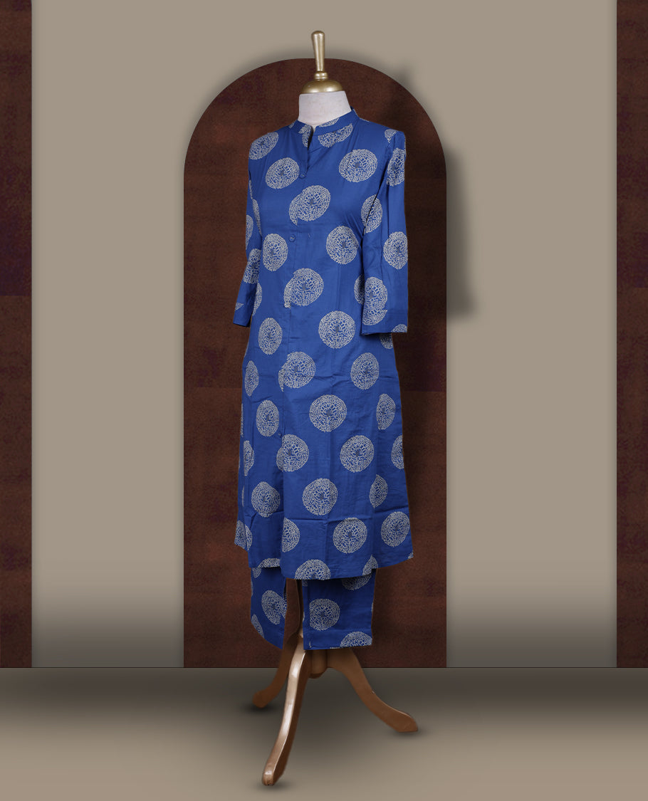 Brick blue colour cotton cord set featuring a straight kurta with a mandarin collar, front buttons, and three quarter sleeves & adorned with white circular block prints and paired with matching palazzo pants.