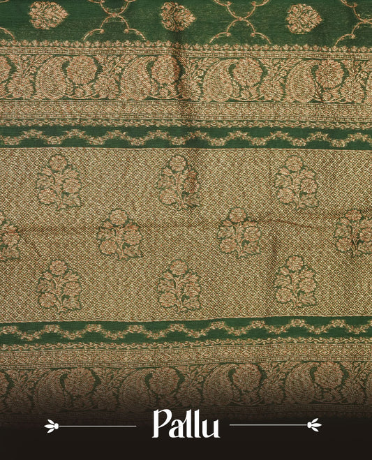 Deep forest green semi Banaras saree with gold zari buta motifs, finished with a traditional gold zari border and pallu, paired with a matching blouse.