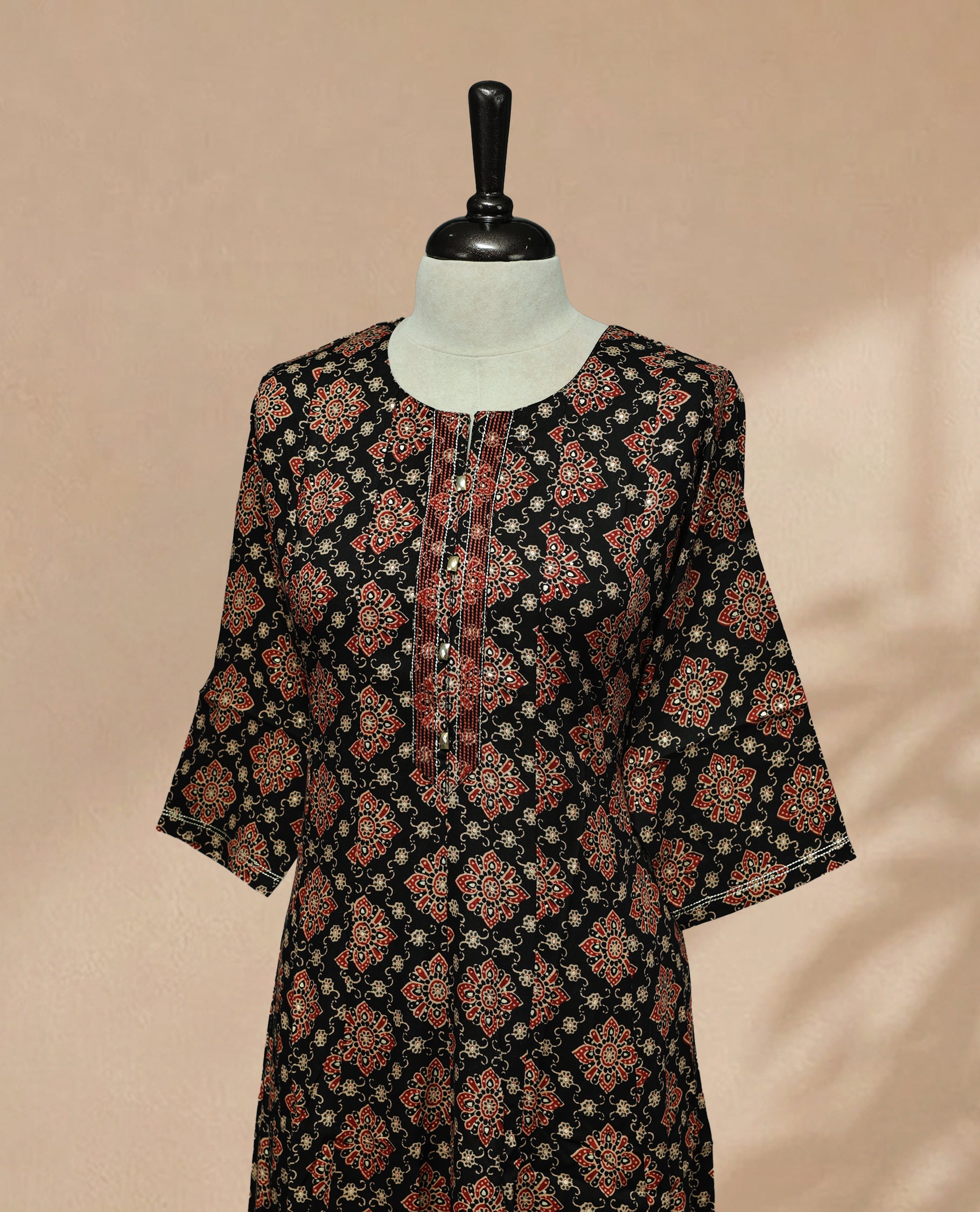 Black colour kurti featuring classic u neckline,  floral prints on body, Comes with sleeve.
