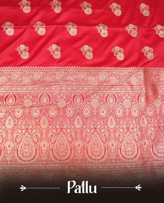 Bright red colour Banaras Satin Crepe saree featuring gold zari floral motifs on the body, a richly woven traditional border with intricate gold zari detailing, and paired with a matching blouse.