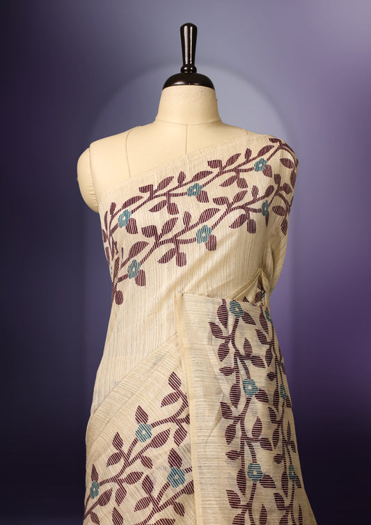 off white colour Kota net saree featuring a delicate floral kodi border with a plain body, paired with a matching blouse.