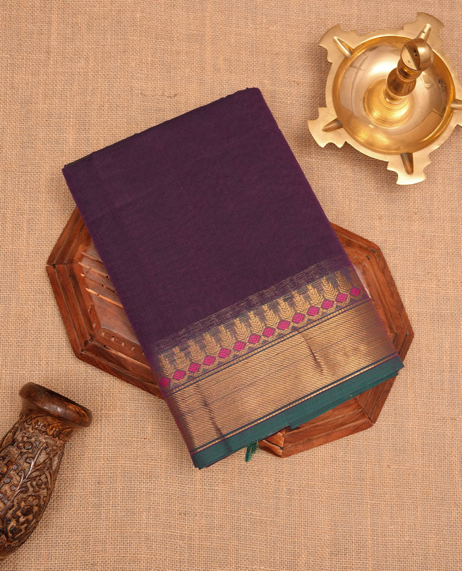 Purple colour chettinad cotton saree featuring Elegant plain body, contrast green colour border with gold zari border, pallu and paired with matching blouse.