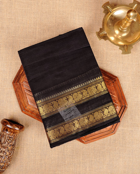 Dark Navy Blue colour chettinad cotton saree featuring plain body, with matching traditional gold zari border paired with matching blouse.