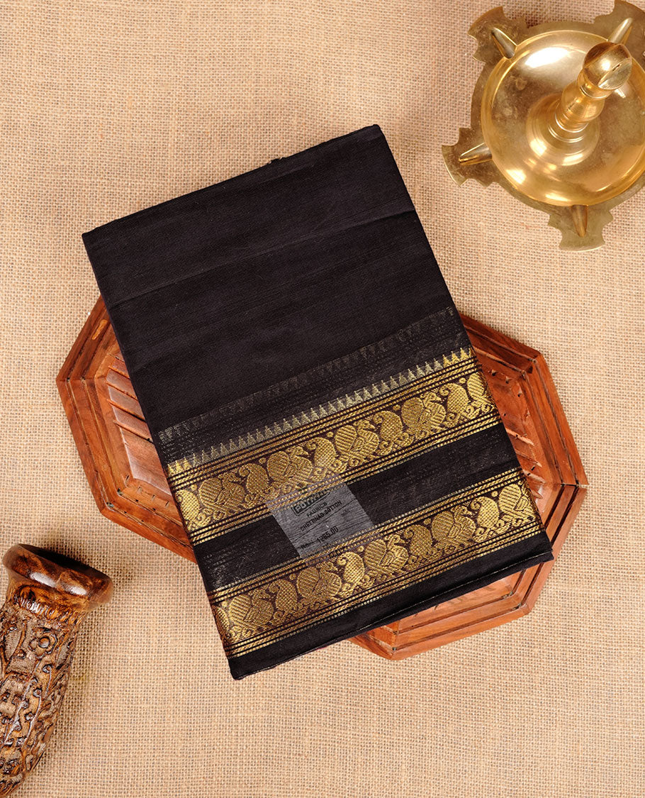 Dark Navy Blue colour chettinad cotton saree featuring plain body, with matching traditional gold zari border paired with matching blouse.