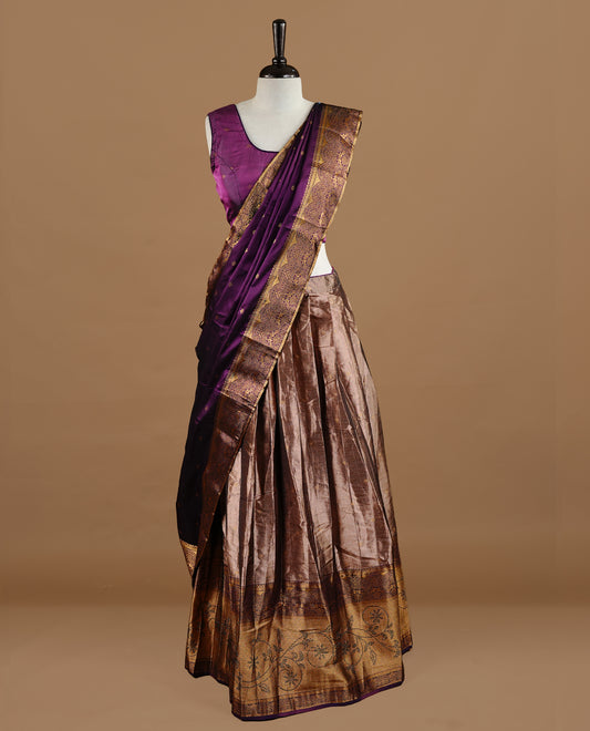 Purple colour Half saree featuring Purple colour skirt with contrast gold colour border with stone work, paired with contrast antique colour stitched blouse piece, with matching dupatta.