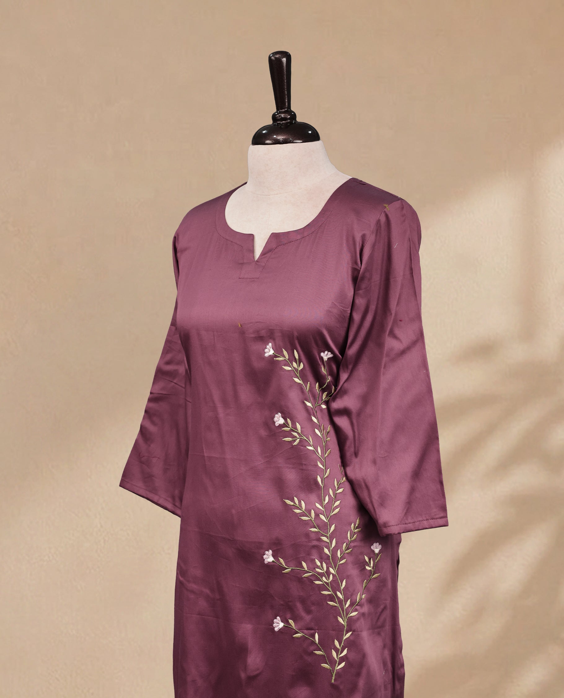 Old Plum kurti featuring a classic U-shaped neckline, delicate  floral vine embroidery on the body, and sleeves.