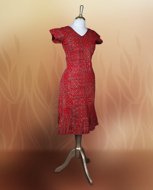Red colour nightwear with traditional patch style prints in black and white, Features a V neck, puff sleeves, and a ruffled flared hem, A stylish pick for festive occasions, casual wear, or ethnic flair.