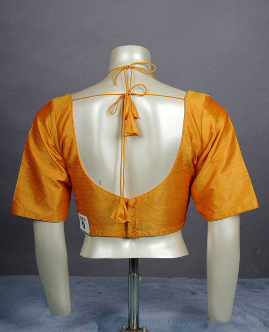 Golden yellow colour silk padded readymade blouse with elbow-length sleeves, a V-neck front, and a deep U-back with tie-up dori.