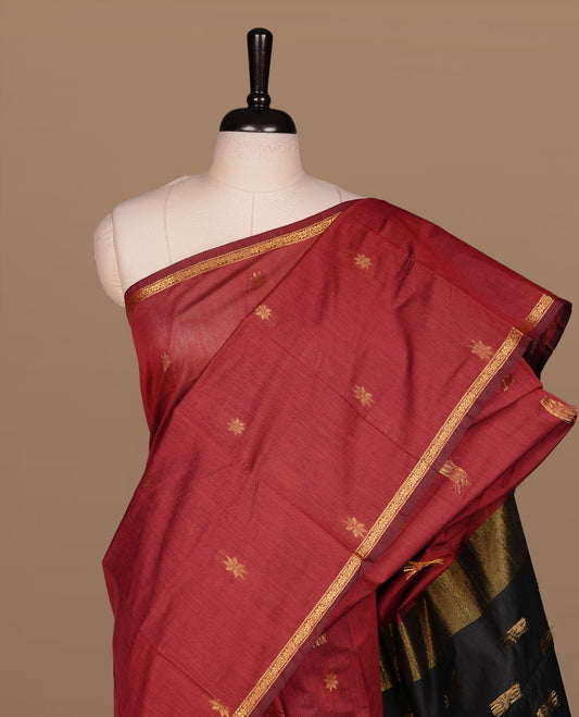 Maroon colour Maheshwari cotton saree features elegant gold zari motifs across the body, a classic gold zari border, a striking contrast pallu, and a matching blouse piece.