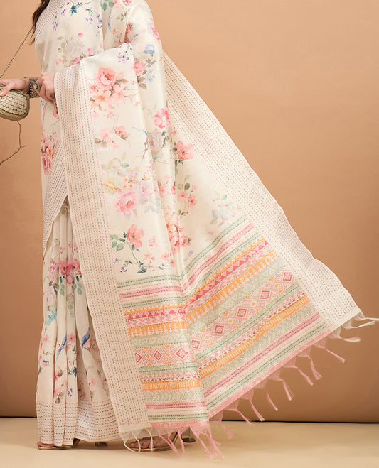 Cream toned semi tussar saree featuring delicate multicolour floral prints on the body, accented with a pastel hued Katha style stitched border and peach & green printed pallu Comes with a matching floral printed blouse for a graceful look.
