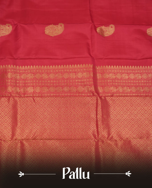 Vibrant red colour pure traditional Kancheepuram silk saree adorned with an elegant zari elephant motif on the body, complemented by a rich gold zari woven border featuring intricate traditional designs, paired with a matching blouse piece.