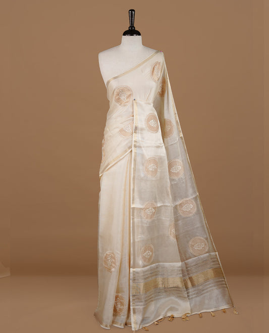 Cream colour Tussar saree featuring gold colour circle pattern with chikankari embroidery work, highlighting gold zari simple border, paired with matching unstitched blouse.