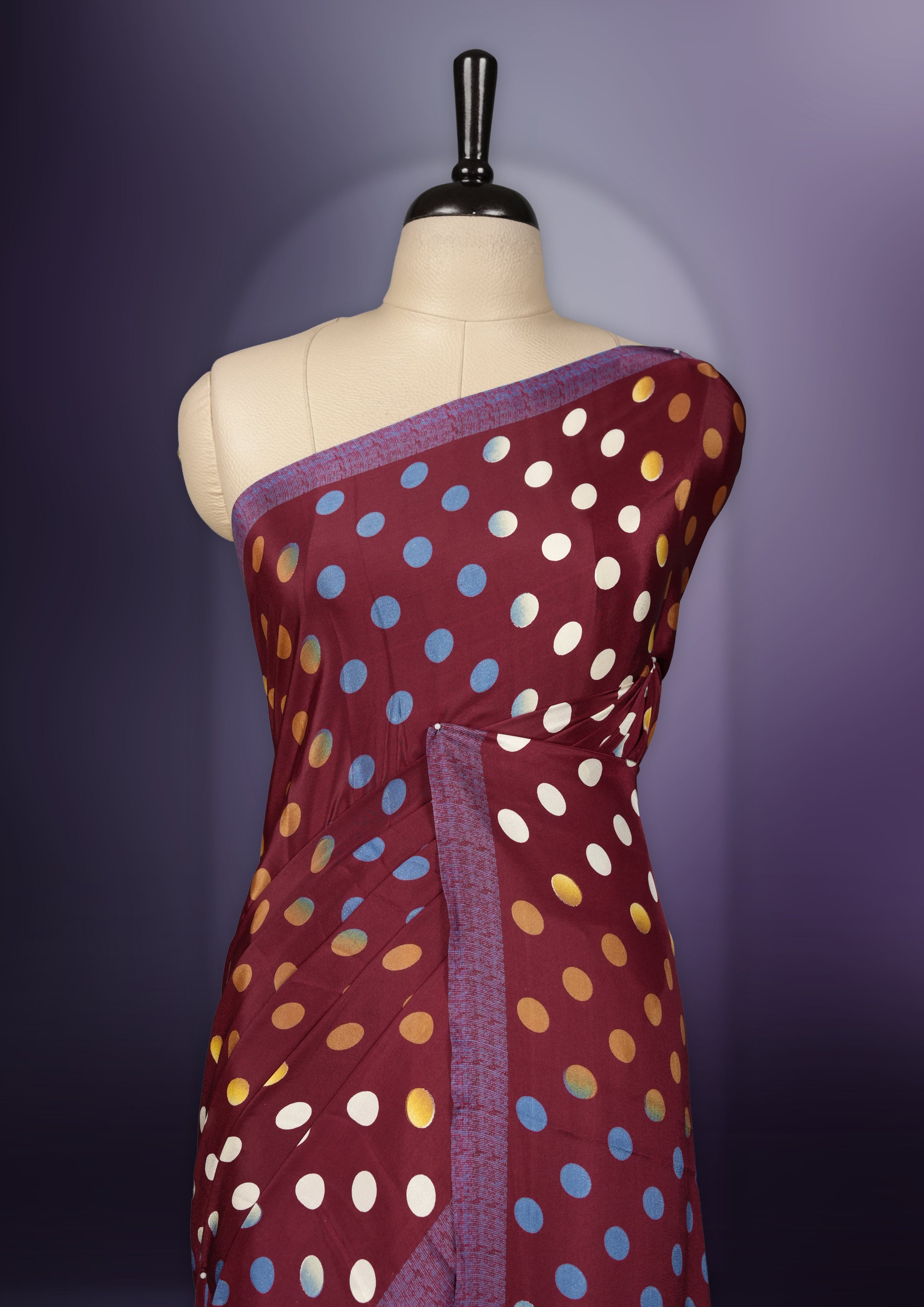Maroon colour saree with with large big polka dots on the body, self stripped pallu & Comes with a stylish matching blouse.