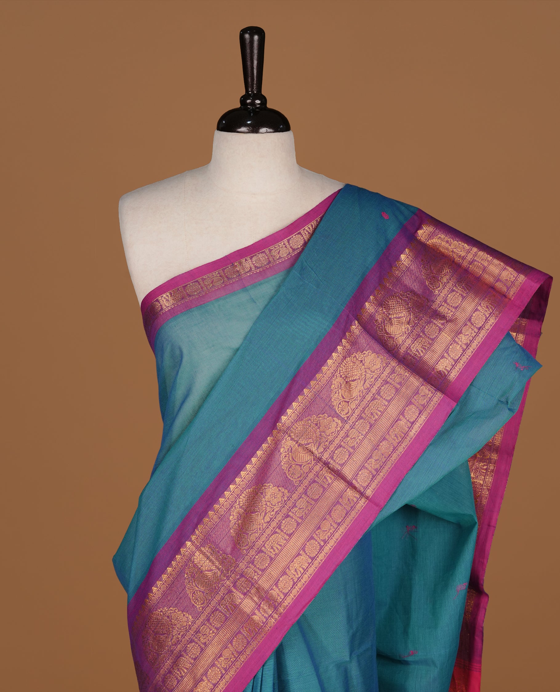 Teal colour Chettinad cotton saree featuring motifs on body , complemented by contrast Magenta colour with zari border, comes with matching blouse piece.